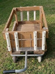 an old wooden toy car with chains on the front and back wheels is sitting in the grass