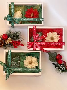 three boxes with christmas decorations in them