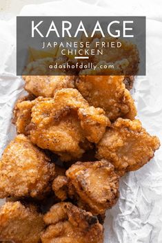 some fried chicken sitting on top of paper with the words karaage japanese fried chicken above it