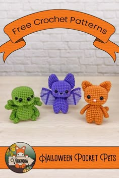 three little crocheted animals sitting next to each other on a table with an orange ribbon