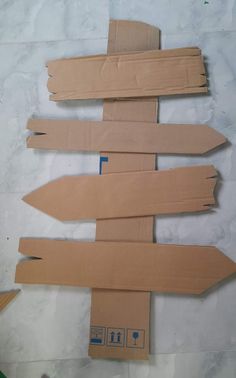 several cardboard signs are laid out on the floor and ready to be cut into pieces