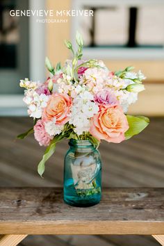 a vase filled with flowers sitting on top of a wooden table