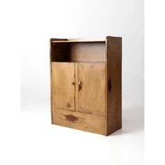 an old wooden cabinet sitting on top of a white floor