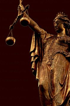 a statue of lady justice holding the scales