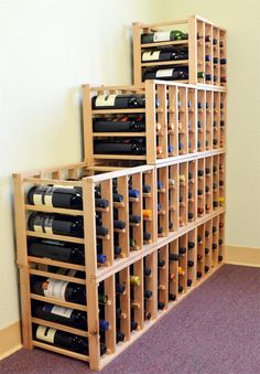 several wine bottles are stacked on top of each other in a room with carpeted flooring