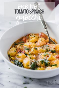 a white bowl filled with macaroni and cheese on top of a marble counter