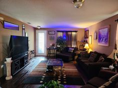 a living room filled with furniture and a flat screen tv