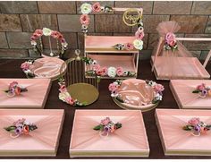 there are many pink and white flowers on this table set up for a wedding or bridal party