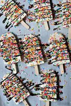 several popsicles with sprinkles and chocolate on them