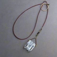 This 3 Point Quartz Lariat Talisman Necklace Is An Original Design By Marie At Blackbird & Sage Exclusively For Her Studio Athene Noctua Jewelry Line. Handmade In Santa Fe, Nm. Features Made To Order Boho Style Lariat Talisman Necklace 3 Large Quartz Crystal Points Pendant With Chain 2.75 Inches (6.6 Cm) Long, 1.5 Inches (3.8 Cm) Wide Featuring Brass Wire, Brass Beads, Brass Circle With Antique Brass Rolo Chain 2mm Red/Brown Untreated Natural Leather The Stone Quartz - All Chakras Raises Energy Long Copper Necklace, Sage Jewelry, Wire Beads, Long Necklace Boho, Mystical Jewelry, Talisman Necklace, Quartz Crystal Pendant, Santa Fe Nm, Quartz Jewelry