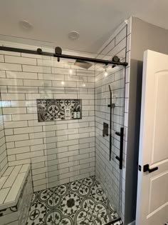 a walk in shower sitting next to a white door with black trim on the walls