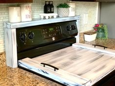 a stove top oven sitting inside of a kitchen