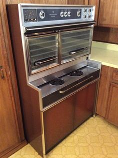 an oven with two burners is in the middle of a kitchen flooring area