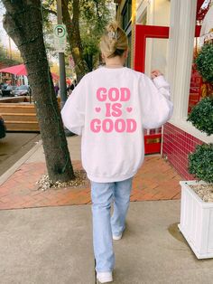 a woman is walking down the sidewalk wearing a sweatshirt that says be cool or leave