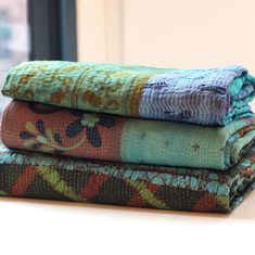 Description Kantha throws are handmade in India. Each is unique. Layers of upcycled sari fabric have been hand-stitched to make something new and beautiful. After the careful work of stitching and patching, each throw is dyed in a rich color to create a more uniform hue. Choose from Burgundy, Gold, Green, Turquoise, or Blue. Please note: each throw is completely unique. The photos represent examples of each color. The kantha throw you receive will be a one-of-a-kind work of art. Details Approxim Color Story, Sari Fabric, Kantha Throw, Burgundy And Gold, Women Artisans, Embroidery Techniques, Green Turquoise, Sale Event, Purple Color