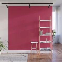 a living room with red walls and wooden floors