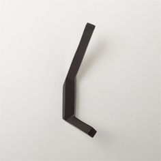 a black handle on a white wall