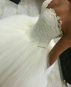 a woman in a wedding dress looking down