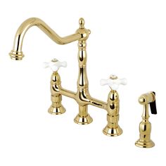 a golden faucet with two white handles