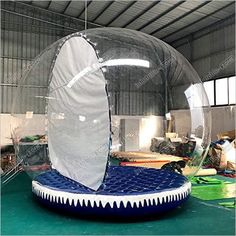 an inflatable ball with a shark fin on the bottom and inside it, is shown