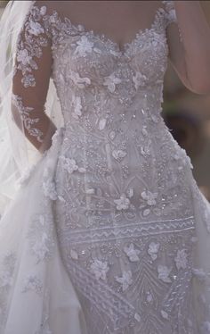 the back of a wedding dress with flowers on it