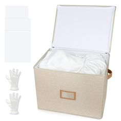 an open storage box with white sheets and gloves in front of the lid, on a white background