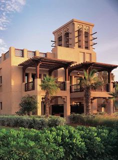 a large building with many balconies on the top floor and two stories above it