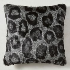 a black and white animal print pillow sitting on top of a wall