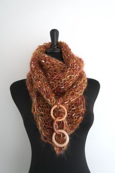 This elegant and sumptuous kerchief is a true fashion statement and is sure to draw attention. You can wear it in so many ways. Just look at the pictures to get some ideas. I knitted this mini shawl from a soft mohair acrylic yarn and embellished with wooden rings. More scarves - https://www.etsy.com/shop/KnitsomeStudio?section_id=6751131 More shawls - https://www.etsy.com/shop/KnitsomeStudio?section_id=6598836 Don't forget to check out my other items! There are many more in my shop -- https://w Brown Shawl Scarf One Size, One-size Brown Shawl, Handmade Brown Shawl Scarf, Brown Shawl Scarf, Brown Bohemian Scarves One Size, Brown Winter Scarves For Gifts, Brown Winter Scarves For Gift, Handmade Elegant Scarves One Size, Handmade Brown Scarves For Gifts