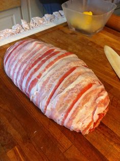 a large piece of meat sitting on top of a wooden cutting board