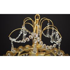 a gold chandelier with crystal drops hanging from it