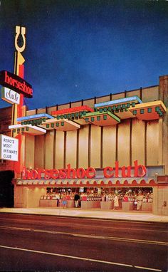 an old photo of the outside of a restaurant at night with neon signs on it