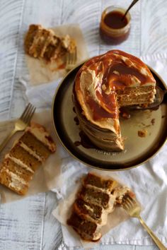 a plate topped with cake next to slices of cake on top of napkins and forks