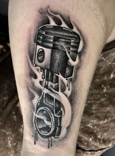 a man's arm with a black and white tattoo of a motorbike on it