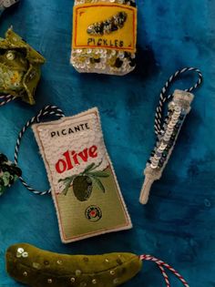 an assortment of decorative items displayed on a blue cloth tablecloth, including a pickle