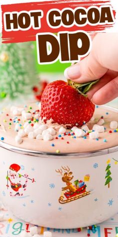 someone is dipping a strawberry on top of a bowl with marshmallows and sprinkles