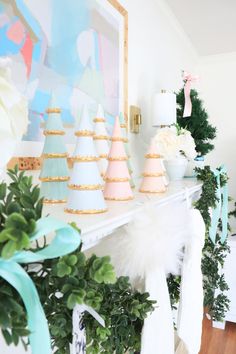 there is a mantle decorated with pastel colors and decorations for the holiday season in this room