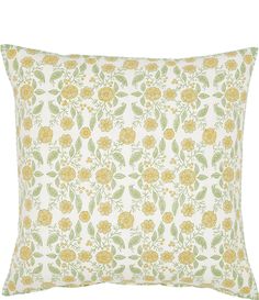 a yellow and green floral pillow on a white background