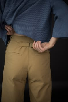 a person wearing tan pants and a blue shirt