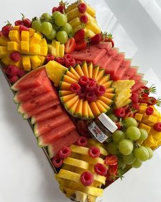 an assortment of fruits arranged on a platter