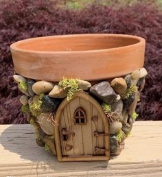 a potted planter with a house built into it