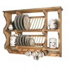 a wooden shelf filled with plates and cups