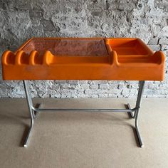 Rare tangerine orix desk by nani prina & vittorio parigi for molteni, 1970's. Molded out of abs plastic. The troughs are intended as letter holders or utensil holders. No chips or cracks, but has some scratches, stains on the desk top and some (rusty) spots on the base.    the dimensions are 75 cm h at writing desk height (heigest point 81 cm) x 102 cm w x 64 cm d    the desktop is 11 cm h, the space beneath for legs 64 cm h . The dimensions of the inner  left front compartment is 26 cm h x 36 c Utensil Holders, Desk Height, Letter Holder, Desk Top, Utensil Holder, Space Age, The Desk, Writing Desk, The Space