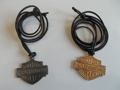 THIS IS A VINTAGE HARLEY DAVIDSON PENDANT NECKLACE. IT IS A GENUINE HARLEY DAVIDSON ITEM. THEY ARE FROM THE 80's. OLD STOCK. THEY COME ON A LONG BLACK CORD. ONE IS PEWTER AND THE OTHER ONE IS COPPER COLOR. THE COPPER COLOR ONE HAS SOME TARNISH ON THE BACK THAT YOU CAN SEE IN THE PICTURE. I DON'T KNOW WHAT KIND OF METAL IT IS. THEY MEASURE 1 1/2" WIDE x 1 1/4" HIGH. THEY HAVE THE HARLEY DAVIDSON LICENSING ON THE BACK. YOUR CHOICE. THEY WOULD WORK WELL FOR A MAN OR WOMAN. A THOUGHTFUL INEXPENSIVE Adjustable Black Biker Jewelry, Motorcycle Jewelry, Motorcycle Necklace, Harley Davidson Crop Top, Harley Davidson Vintage, Biker Accessories, Motorcycle Chain, Vintage Harley Davidson, Vintage Harley