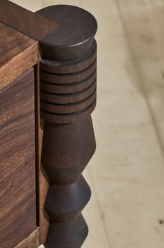 a close up view of a wooden door handle and knobs on a wood cabinet