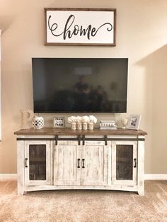 a living room with a large tv mounted on the wall