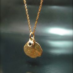 The Necklace And The Pendant Made From 14 Karats Solid Yellow Gold. Pendant Width 0.51inch/ 13mm. Chain Length 17.7inch/ 45 Cm'. 1 Black Diamond 0.02ct Hanging On A Small Pendant. Necklace For Women. Necklace For Men. Gold Handmade Necklace With Two Pendants. One Big, And On Small Bezel Set With Black Diamond. Delicate, And Timeless, A Gift That Each Woman Or Men Like To Have. Chain Available In All Sizes, Color Gold And Karat, And Matte Or Shining Finish. Elegant Black Jewelry With Coin Pendant, 14k Stamped Yellow Gold Nugget Jewelry, Elegant Round Hammered Charm Necklaces, Yellow Gold Hammered Round Charm Necklace, Gold Nugget Jewelry For Jewelry Making, Formal Hammered Pendant Necklace, Round Hammered Fine Jewelry Necklaces, Polished Yellow Gold Nugget Jewelry, Round Hammered Fine Jewelry Necklace