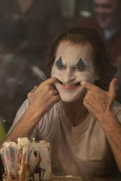 a man with his face painted as the joker