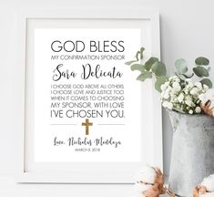 a cross and some flowers on a shelf next to a framed print with the words, god