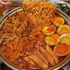 a large metal bowl filled with lots of food